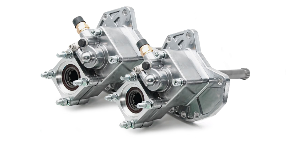 Dual silver power take-off (PTO) units with mounting brackets, shafts, and hydraulic fittings for heavy-duty machinery.